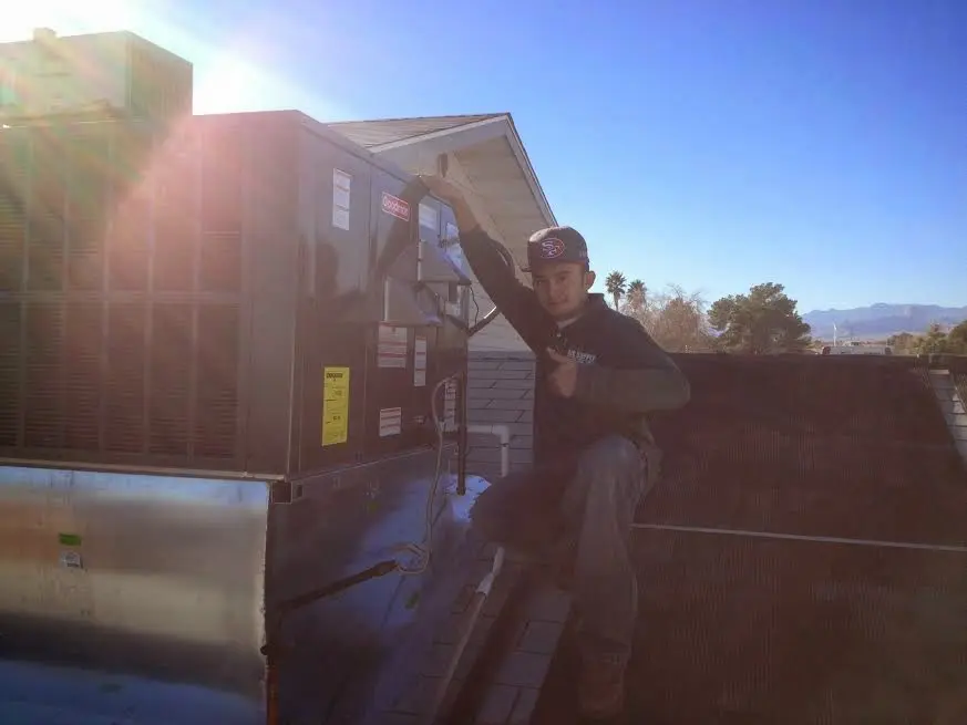 HVAC technician performing HVAC Inspection on a rooftop unit in San Fernando